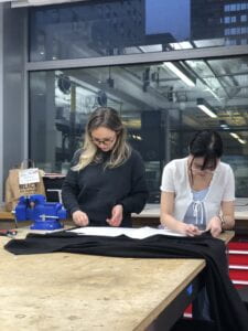 Image of Ploy and Andi cutting the fabric for the vest prototype