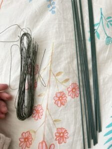 Thin wires and thicker wires lying on bed sheet. Photo shot from top-down view