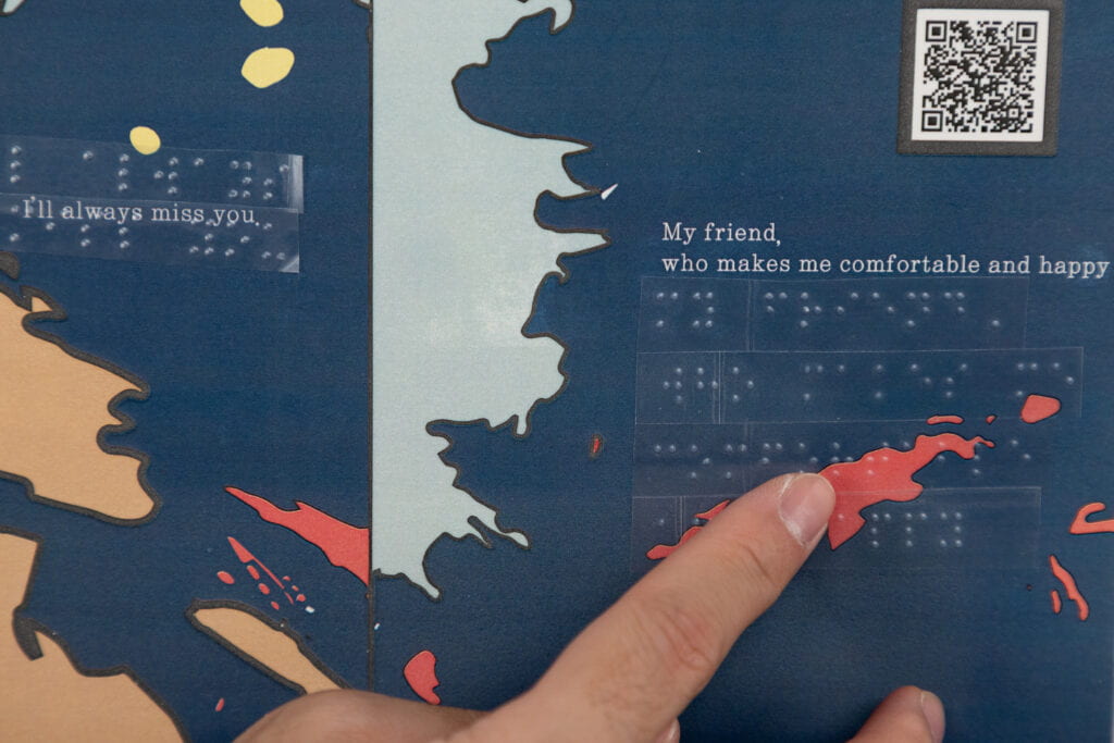 A page of a tactile book with text, tactile graphics, qr codes and braille labels.