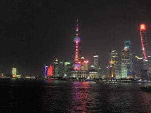 skyscrapers at night alongside river