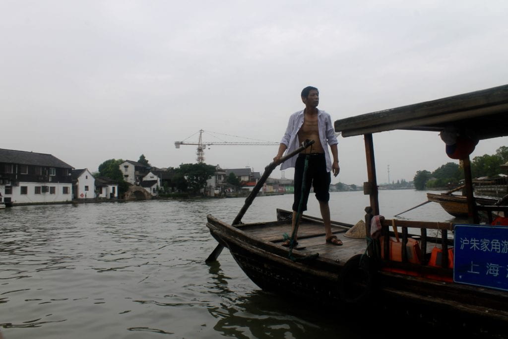 Man standing on boat on the water