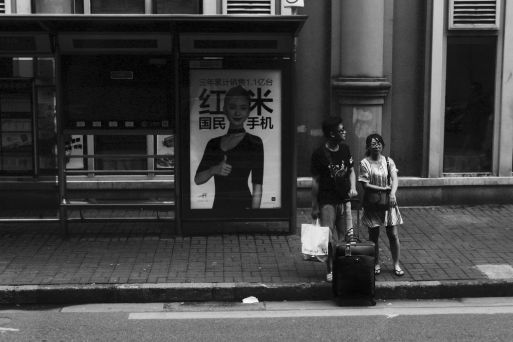 people waiting at a bus stop