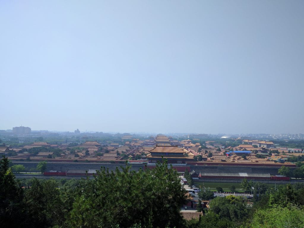 The golden roofs of the Forbidden City on the smoggy backdrop of Beijing