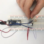 a breadboard with a LED circuit and a potentiometer