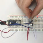 a breadboard with a LED circuit and a potentiometer