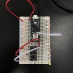 a breadboard with an Arduino Nano connected to 2 pushbuttons and a LED light