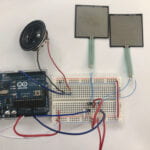 a circuit connected with Arduino, speaker and 2 FSR