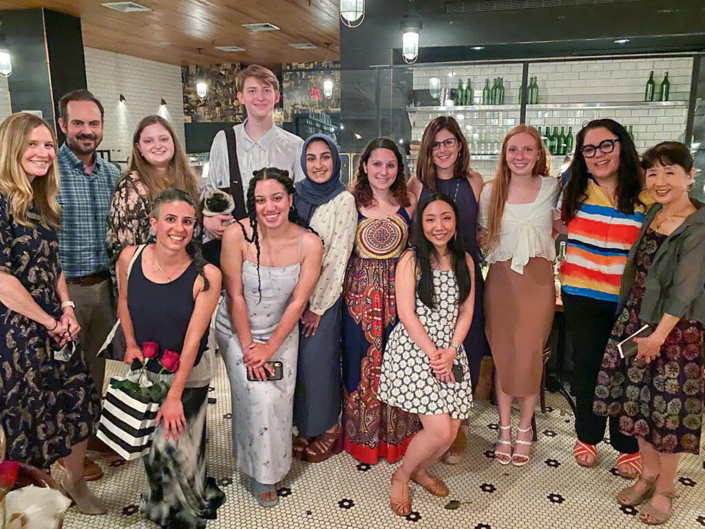 The Art Therapy MA 2021 Cohort stands together at a restaurant with Professors Ikuko Acosta and Marygrace Berberian