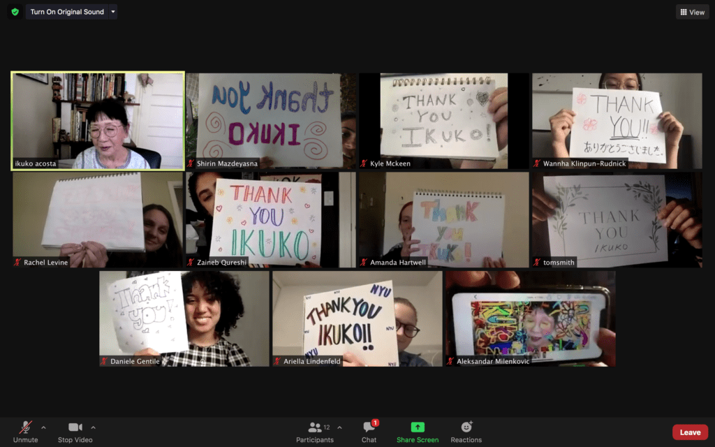 The Art Therapy 2021 Cohort holds up signs that say "thank you Ikuko" in a Zoom meeting. Dr. Acosta is also pictured (she looks very touched).