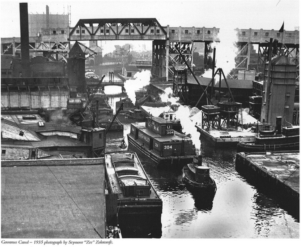 Barges move along the Gowanus Canal and pass under the Culver Viaduct, 1935. Credit: Seymour "Zee" Zolotorofe via The Sixth Borough via Brownstoner.