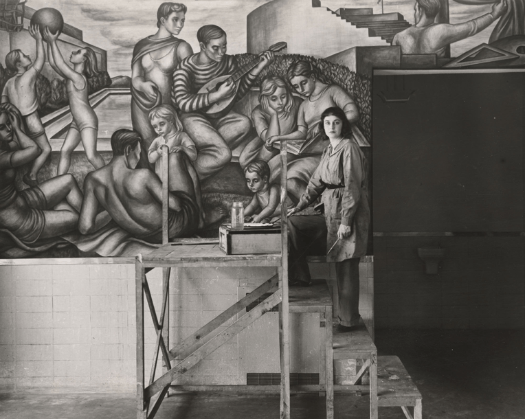 Artist Marion Greenwood with her mural, Blueprint for Living (1939-40), at Red Hook Houses commissioned by the Federal Art Project. Credit: Kian Goh via Twitter