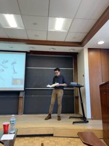 An NYU Student holding a prototype of a 3D printed tactile arm.