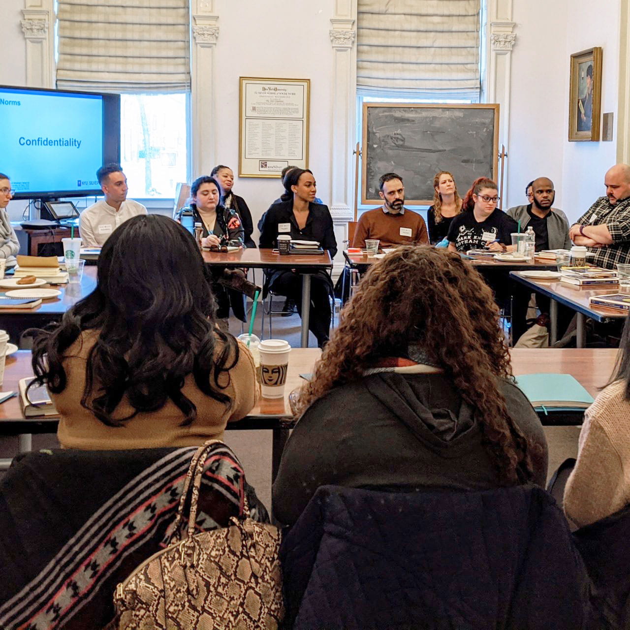 Adaptive Leadership participants seated at tables arranged in a circle discussing Institute norms