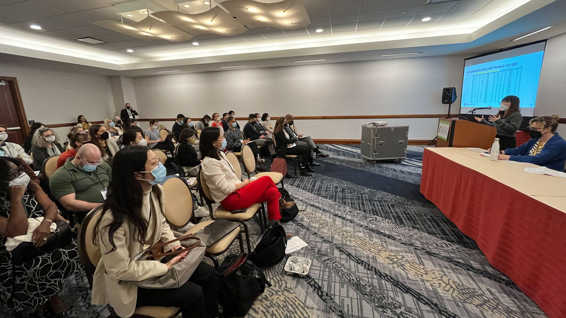 C+M Silver Center researcher Nari Yoo presenting to a seated audience at SSWR 2023