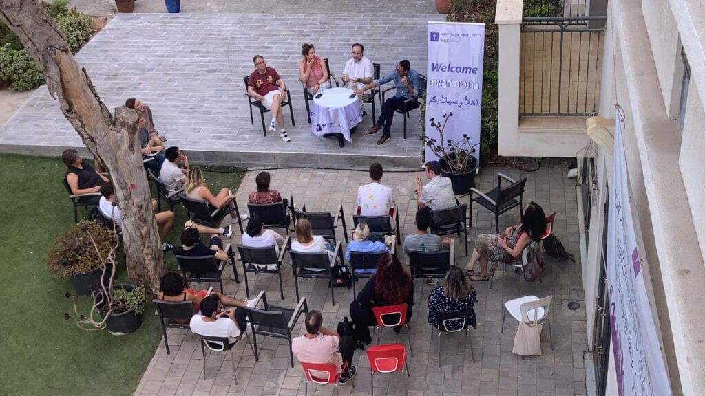 Students and faculty members gathering in the NYU Tel Aviv courtyard for an orientation event.