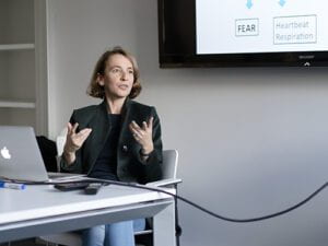 Dr. Frédérique de Vignemont sitting at a desk