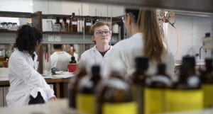 Students in white coats for a lab