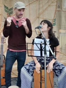 Fiona sitting on a music box in front of a microphone