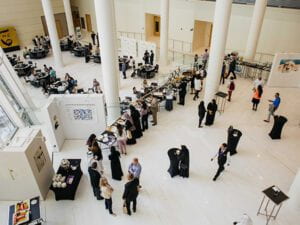 View from above of AD Institute event with people standing, mingling, and getting food