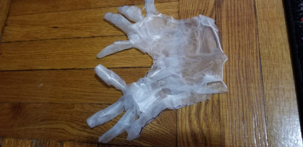 THE 3D MOLD GLOVE WAS CUT IN HALF AND PLACED FLAT ON A HARD SURFACE