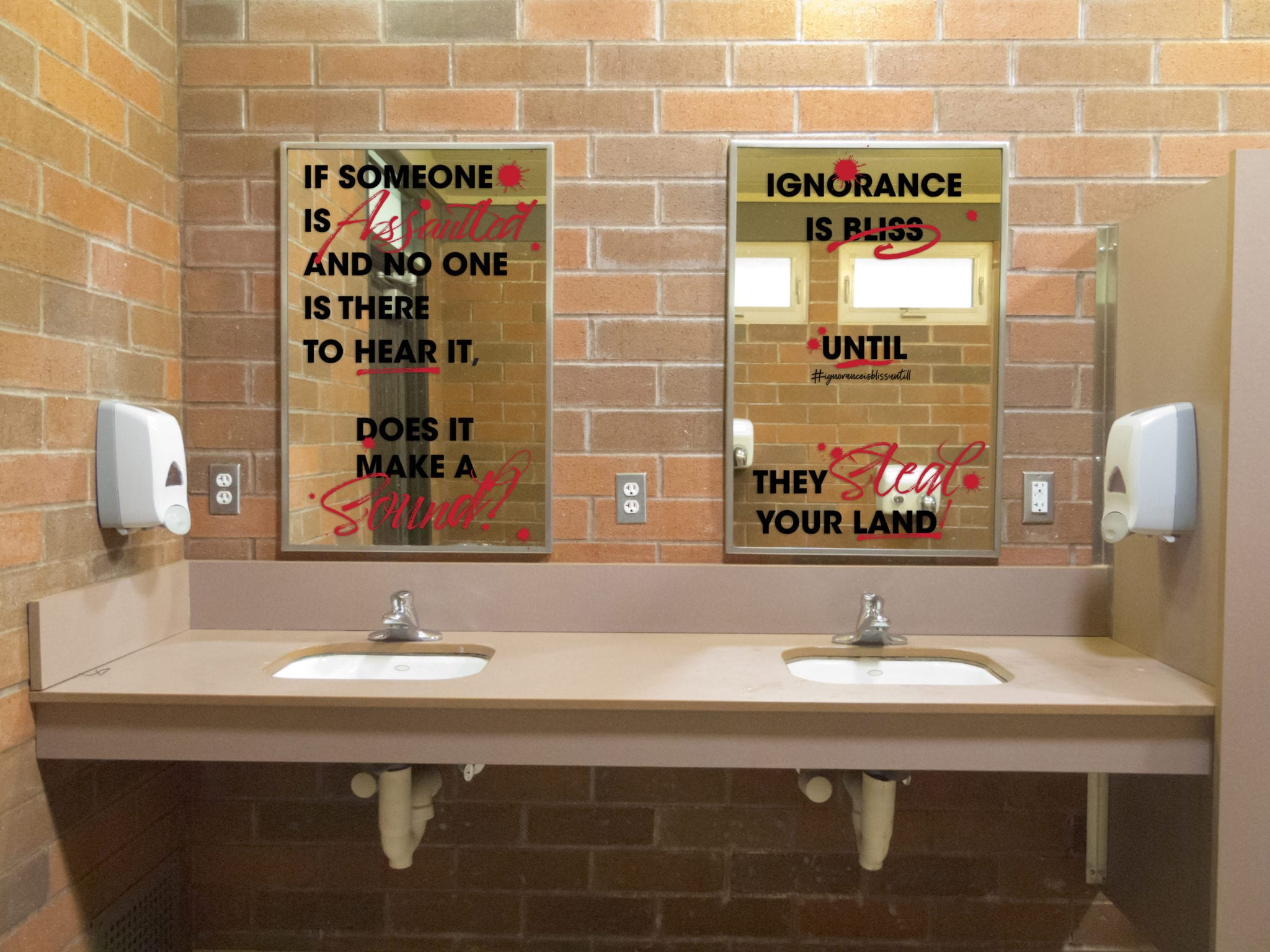 Mock up of public restroom with Ignorance is Bliss mirrors.