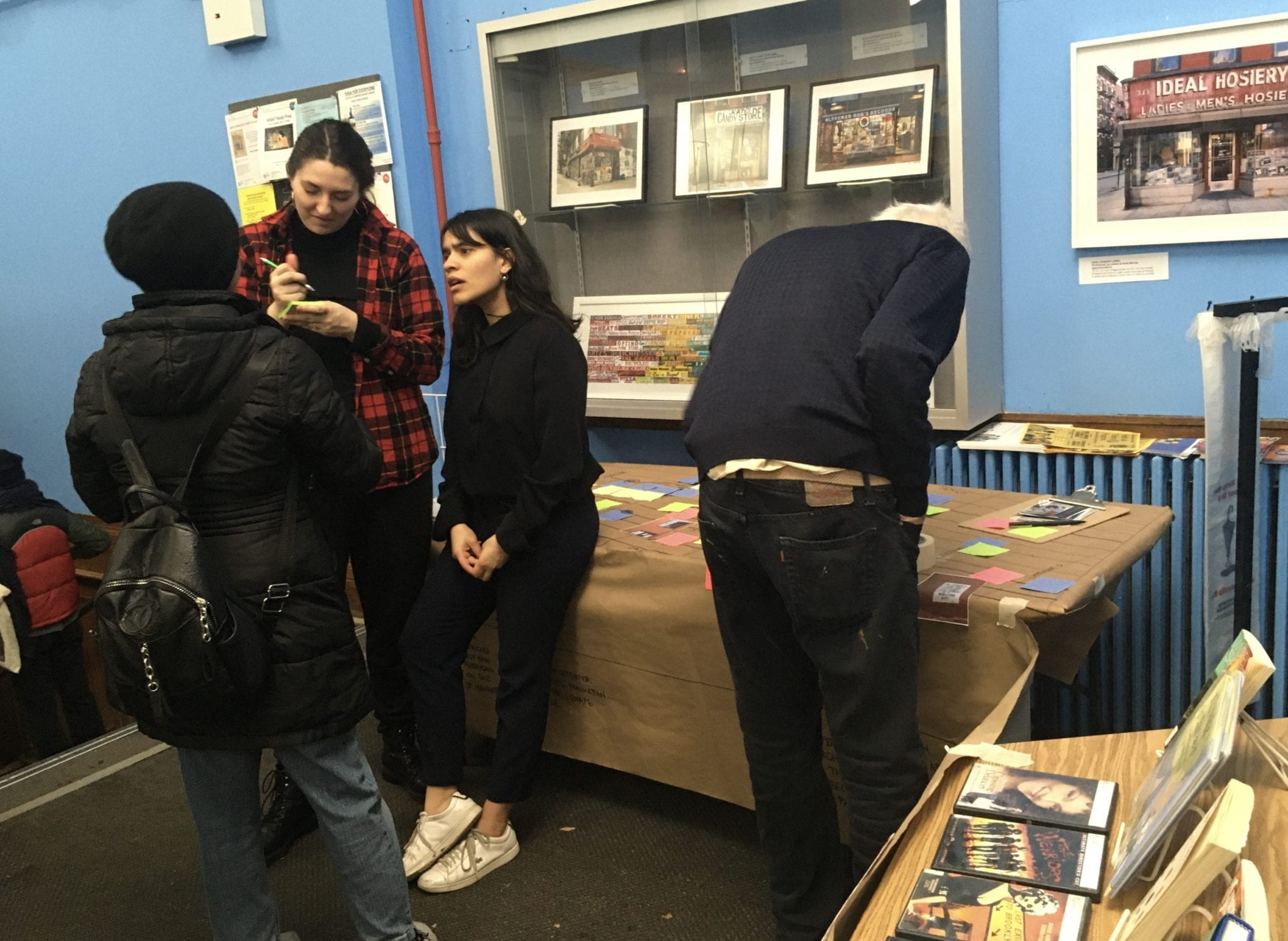 Students listening to a community member share their story in the Tompkins Square Library.