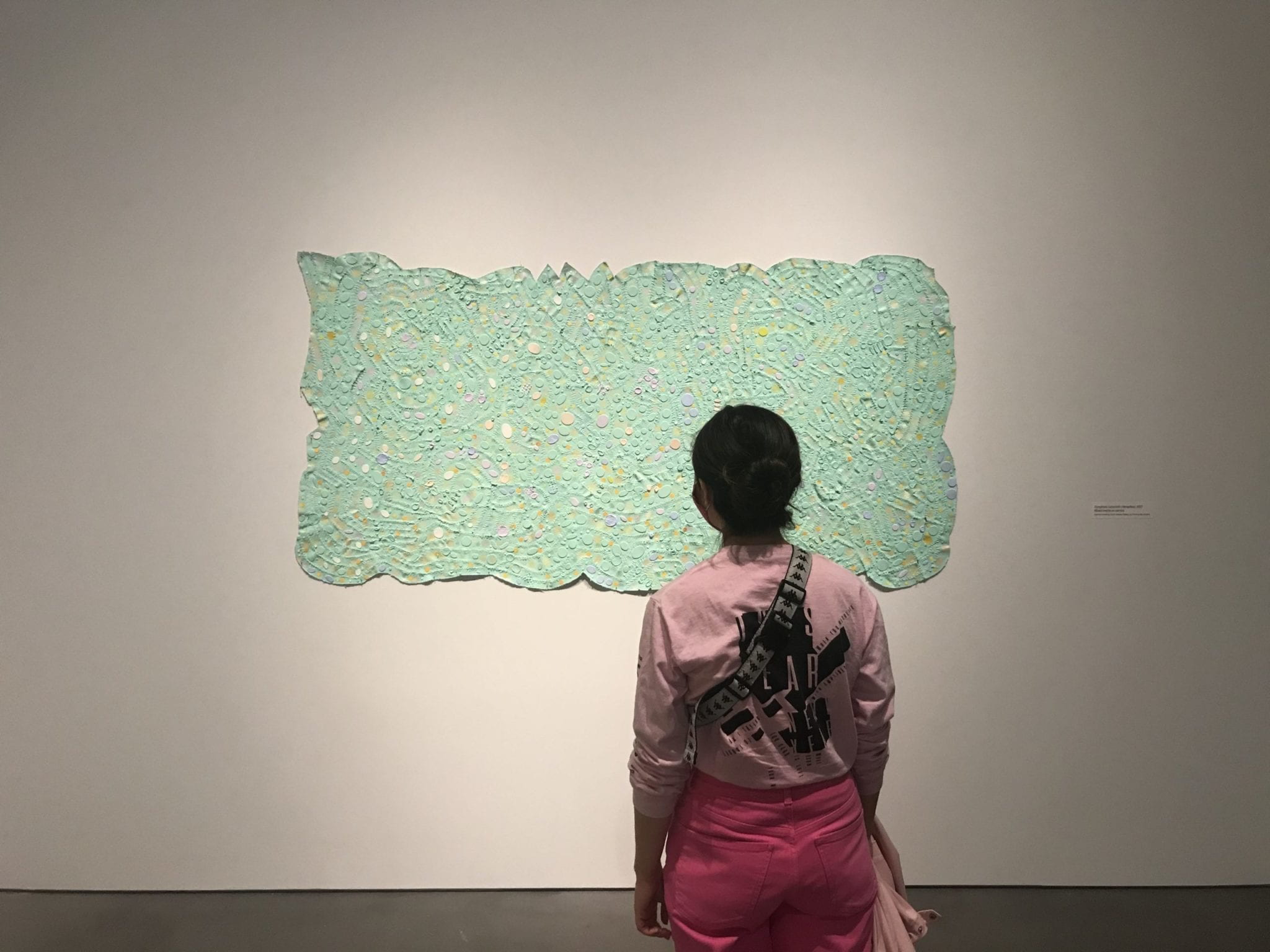 Student looking at Paper and textile artwork by Howardena Pindell exhibition, Rope/Fire/Water at The Shed