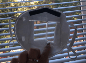 N95 respiratory mask with center opened and a transparent plastic curved window covered the opening in the center of the mask.