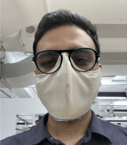 Student wearing fabric mask that fits under glasses to minimize fogging. 