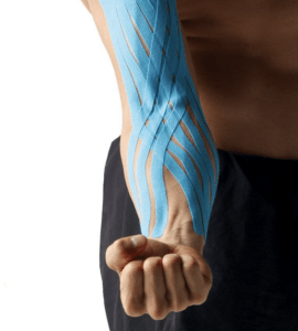 Person's arm with clenched first wearing pre-cut, turquoise kinesio tape.