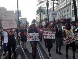 National Moment of Silence march on August 14, 2014 in New Orleans. PIctured left to right are Anita Dee, Samai Lalani, and Mwende Katwiwa. Photo by @Small_Affair