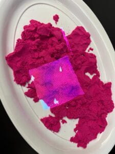 projection on bright pink kinetic sand