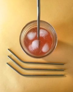 Metal straw in beverage in a glass