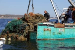 tons of plastic being hauled onto a boat