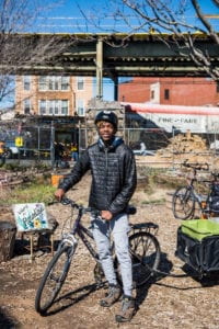 A teen with a bike and wagon