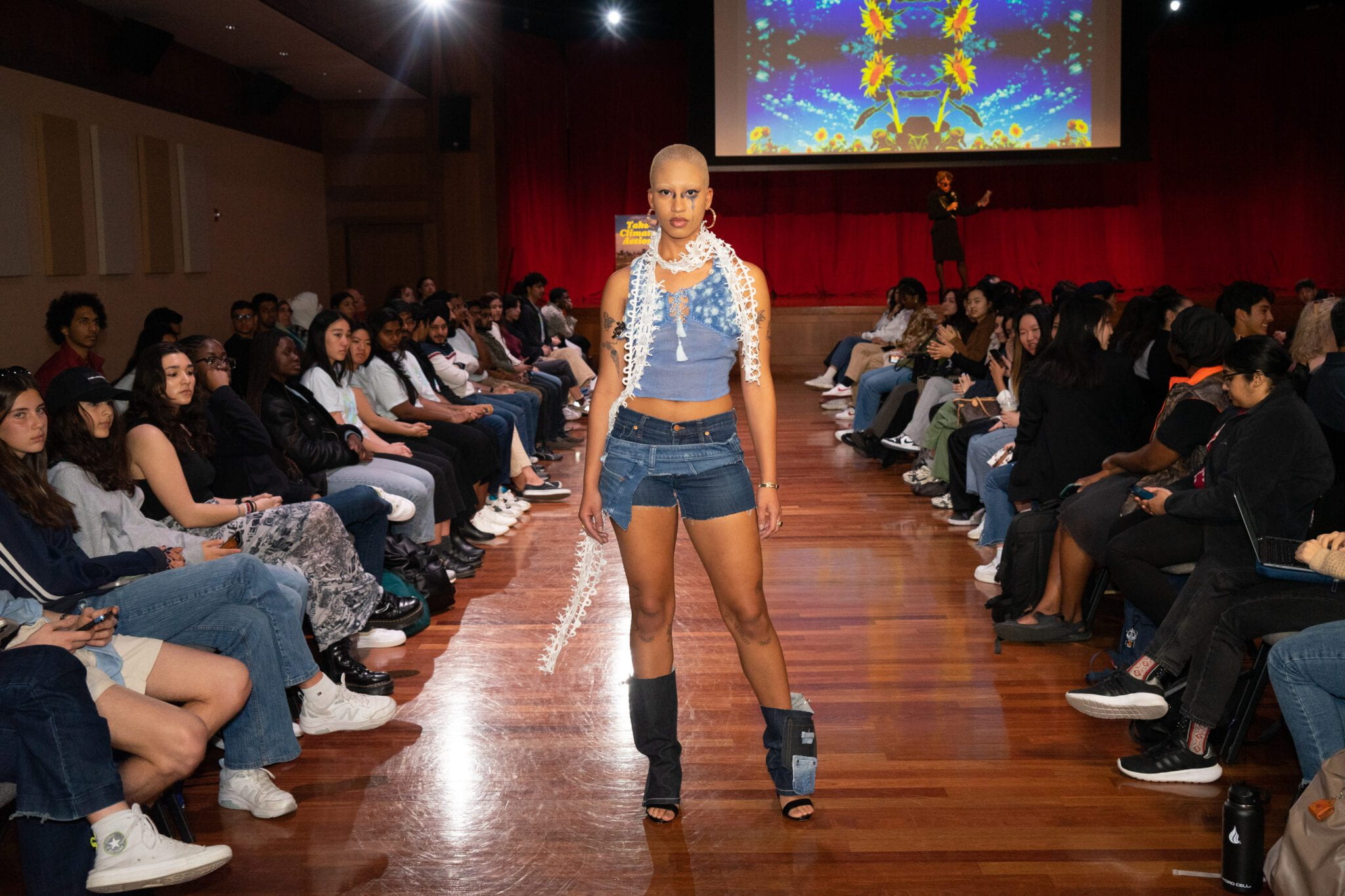 A student modeling designs inspired by upcycling denim. 