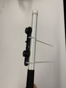 Side view of the Fidlock Twist connected to the cane by zip ties