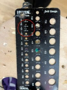 Sheet of multiple drill gauge, screw hole sizes with the 2.38mm screw circled in red