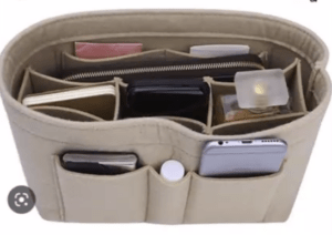 Bag organizer insert pictured with multiple compartments that organize small items 