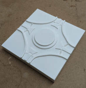 A 3D-printed model of a roundabout, designed using a reference image. Crosswalks are depicted using narrow slits, while the curb is separating the road as well as the islands are raised. 