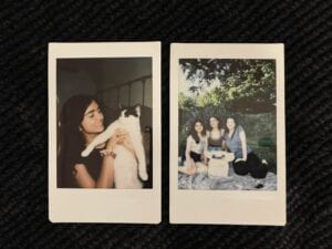 2 Polaroids: 1 of girl and cat and another of 3 girl friends