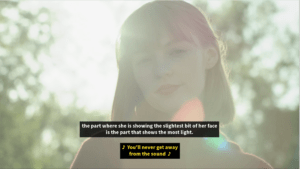 screenshot of girl in video with sunlight behind her