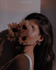 girl holding sunflowers