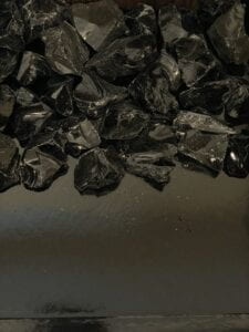 black box full of black crystal rocks