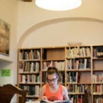 student in the NYU Prague library