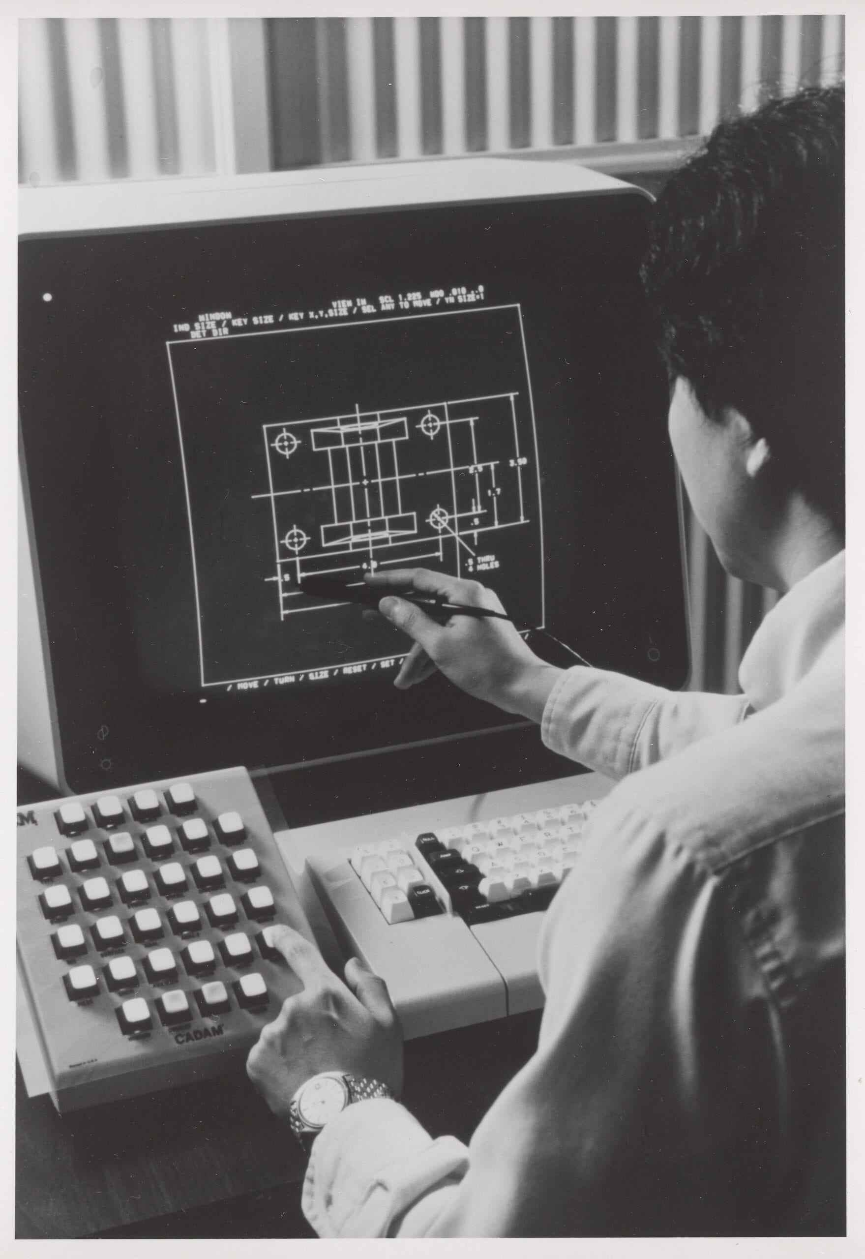 Photograph of an unknown Brooklyn Polytechnic student, manipulating a diagram on a computer screen.