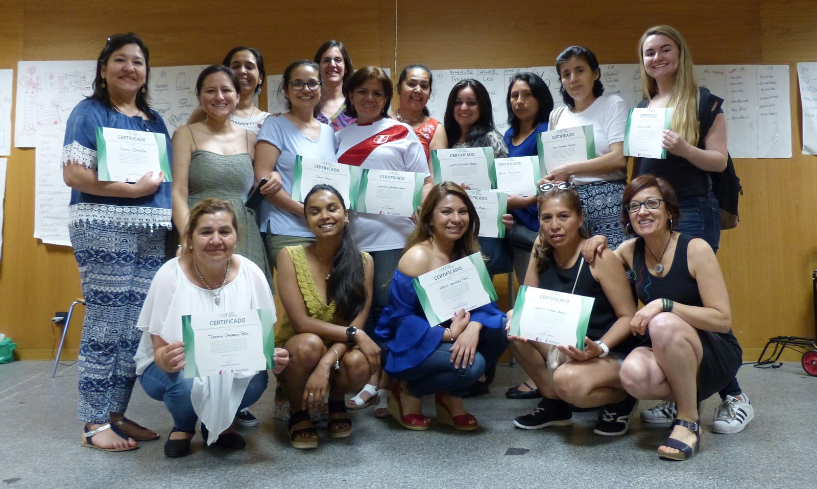 Women holding up diplomas