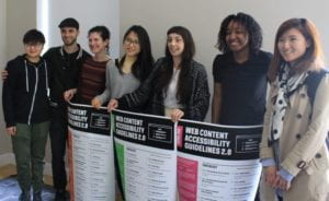 Cooper-Hewitt CoLab students stand in a line holding posters summarizing their work. 