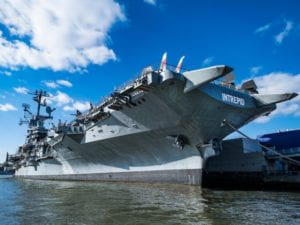 Photo of USS Intrepid airship carrier taken from the water level.