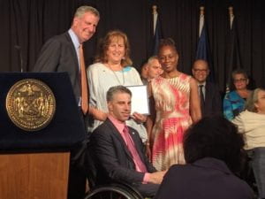 ABILITY Lab Co-Director and Professor Anita Perr accepts ADA Sapolin Award on-stage with Mayor Bill de Blasio, Commissioner Victor Calise, and First Lady Chirlane McCray.